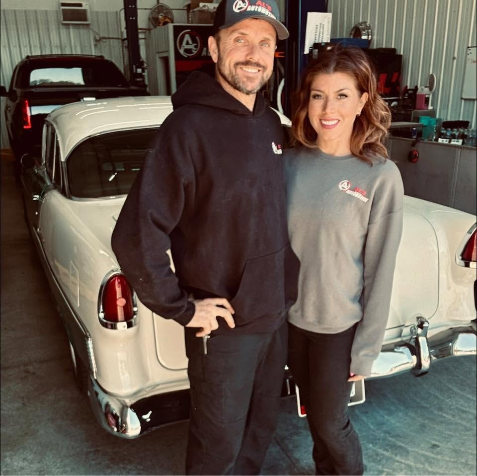 Automotive repair shop team talking in the garage